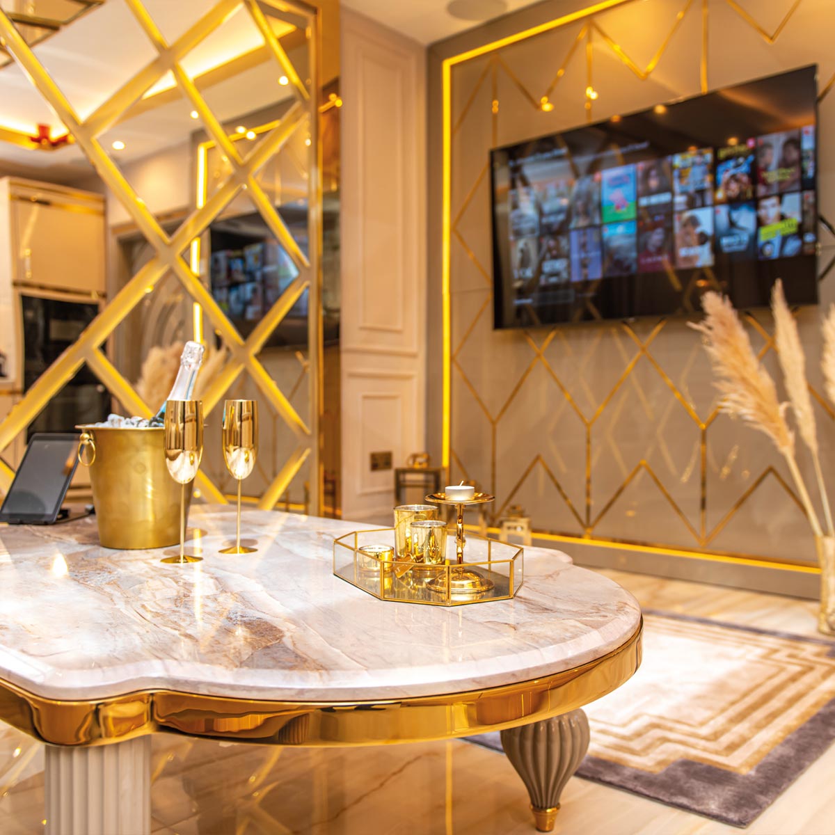 A living room of a serviced apartment decorated in lots gold.