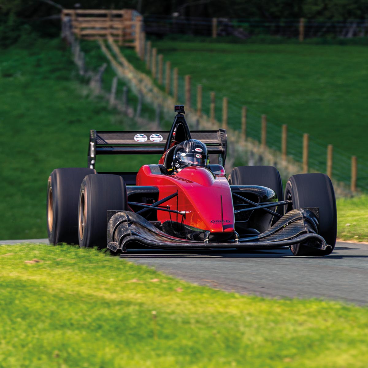 A single seater race car at Harewood Hillclimb approaching a corner.