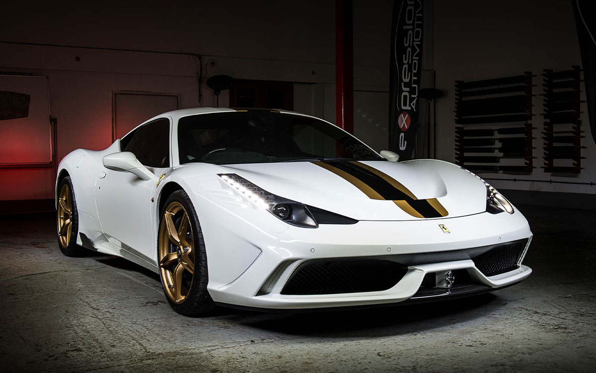 A Ferrari 458 Speciale in a garage with ambient lighting