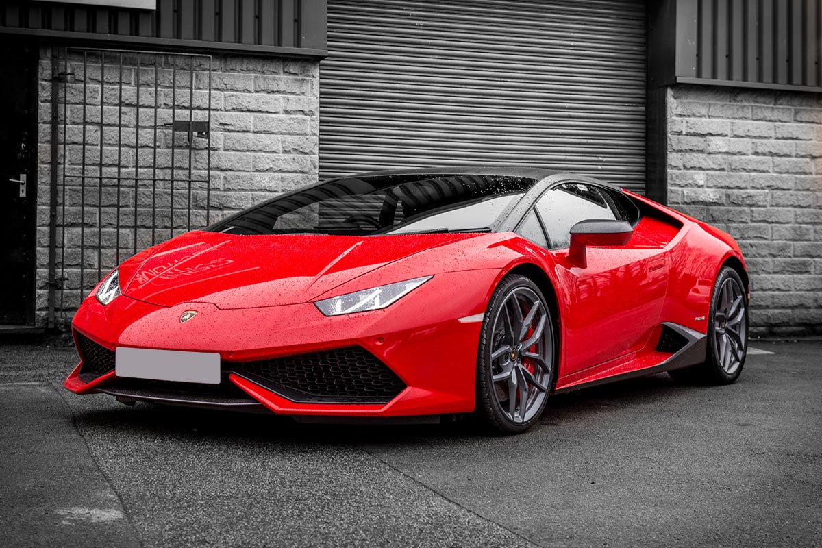 Lamborghini Huracan in red outside a garage