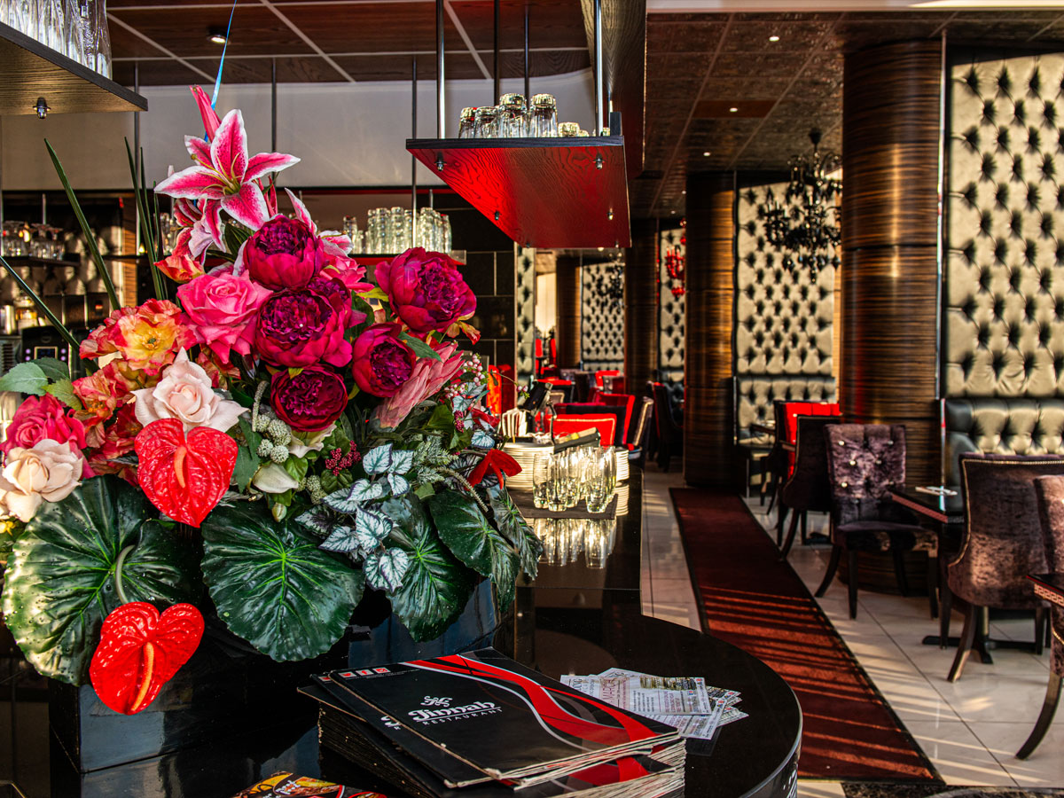 Jinnah Restaurant interior shot at sunset with flowers and dining area